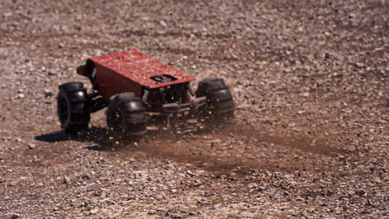 A photo of thuggy driving fast through loose dirt